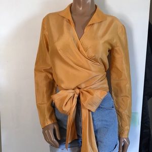 Enygma wrap top. Gold. Size 10. Can be tied in the front, back, or side.